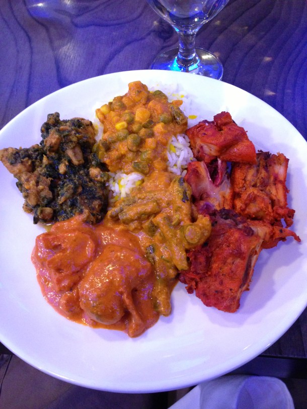 Clockwise starting with Tandoori chicken, aloo beans, butter chicken, sagg chicken, and vegetarian curry