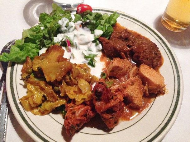Clockwise: green salad, lamb, chicken, vegetable pakora, and eggplant